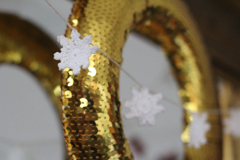 a close up of a gold sequin wreath 